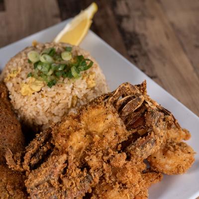 Asian Cajun platter served with rice, close-up.
