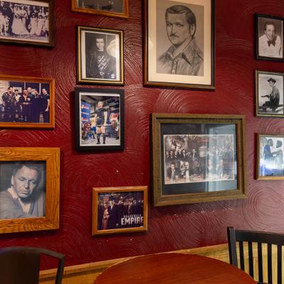 Red wall adorned with framed photos.