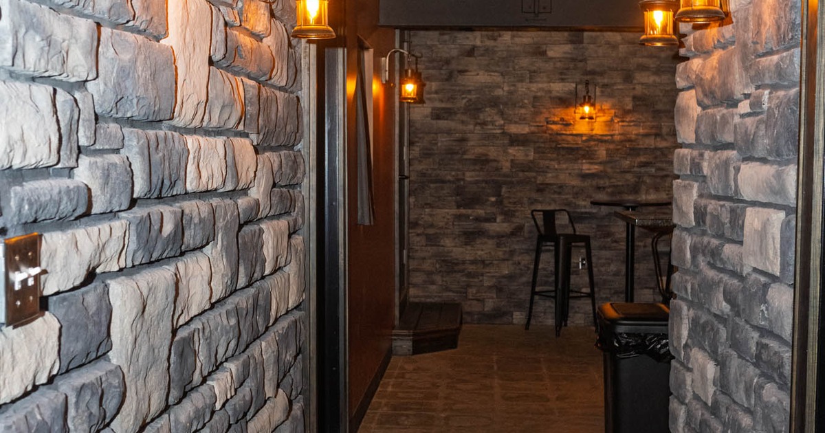 A hallway walls covered in stone tiles