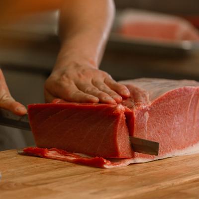 Chef cutting bluefin tuna loin.