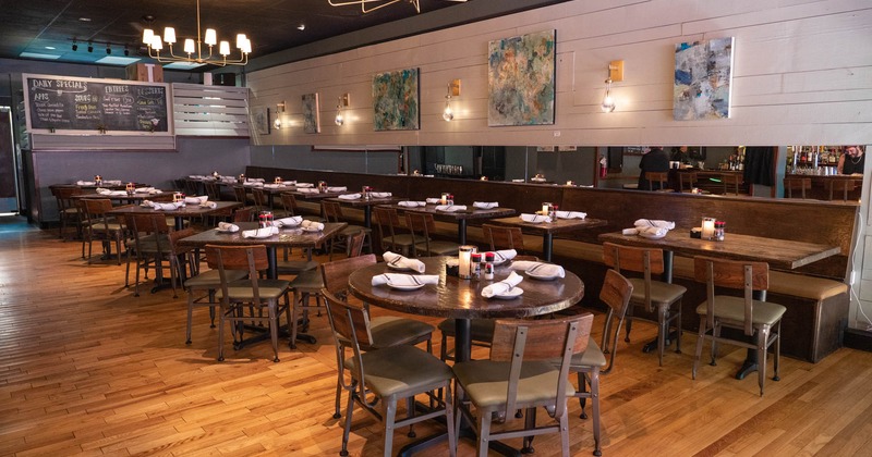 Interior, dining area, long banquette bench with tables, wooden top tables with chairs