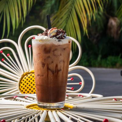 Iced mocha topped with whipped cream and chocolate shavings.