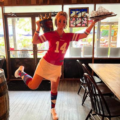 Interior, a server with a beer bucket and a a food tray.