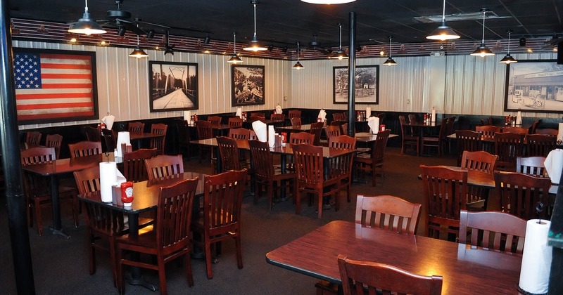 Interior, dining tables, walls decorated with vintage pictures and the US flag