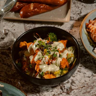 Buddha Bowl with grilled chicken, roasted vegetables and a creamy dressing.