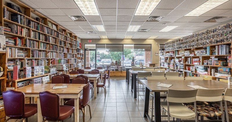 UInterior, wide view, tables and chairs, bookshelves on side