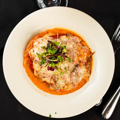 Stuffed pepper smothered in cheese.