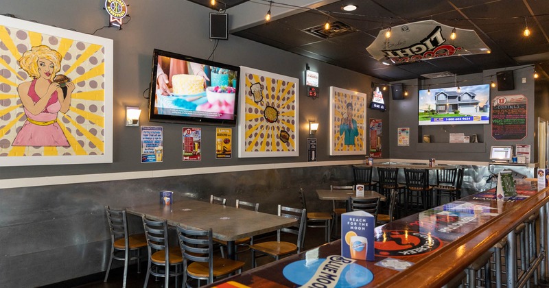 Interior, seating, walls with TVs and pop-art style artwork