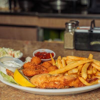 Fried fish platter with breaded shrimp, fries, and dipping sauces.