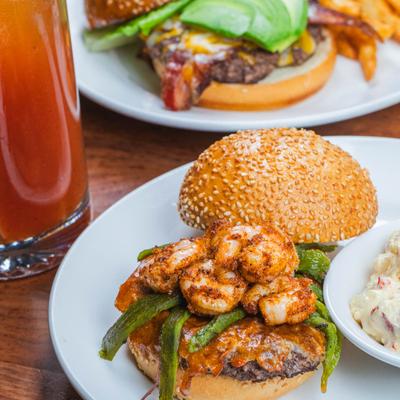 Shrimp burger served with potato salad.
