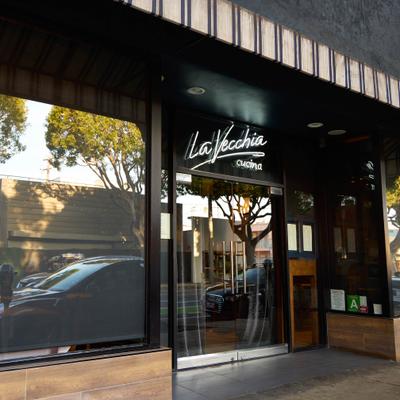 Exterior, restaurant's entrance with a sign.