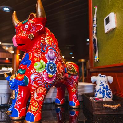 Colorful decorative bull statue on restaurant counter.