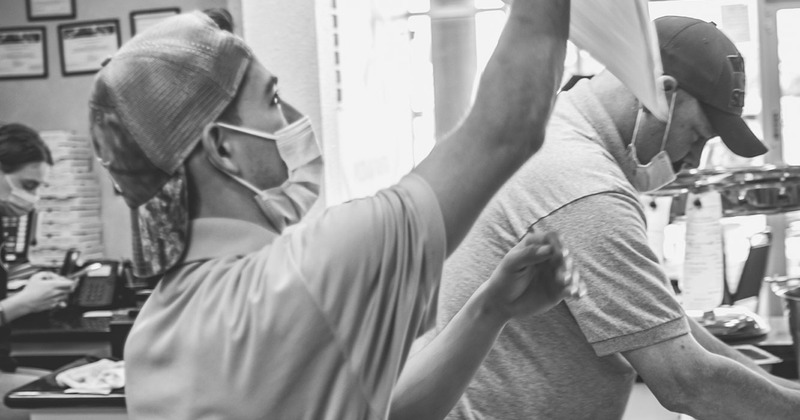 Interior, cooks making pizza