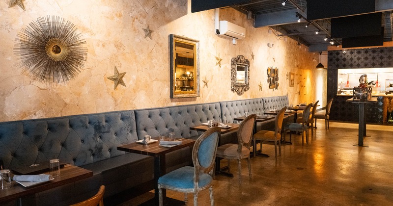 Interior, long seating bench and tables near wall