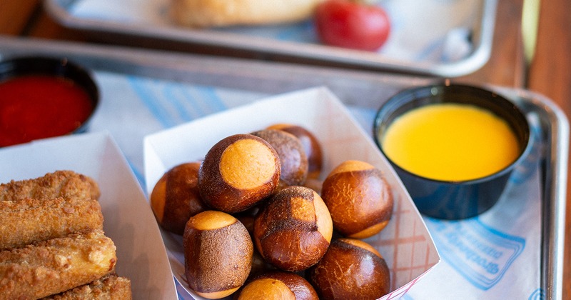 Pretzel bites and mozzarella sticks served with marinara and cheese sauces