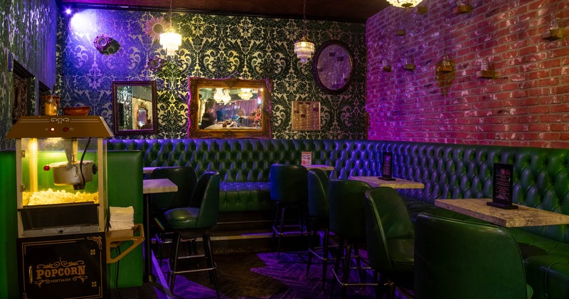 Interior, lounge area, high seating banquette bench with tables and stools, popcorn machine