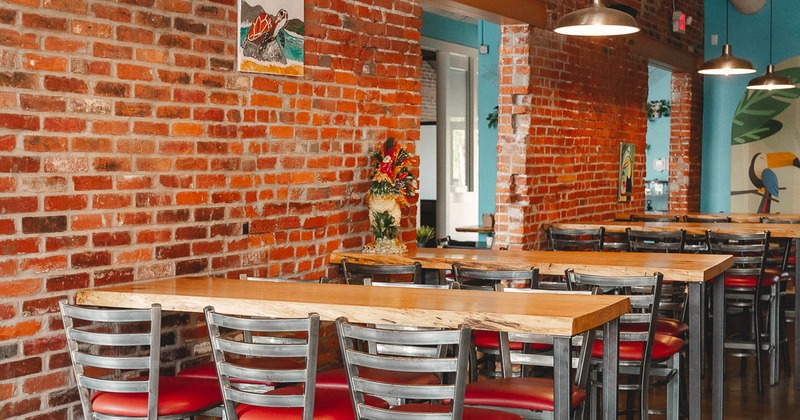 Interior, high tables and chairs near wall