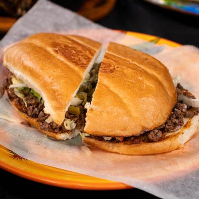 Torta de asada sandwich served on toasted bolillo bread.