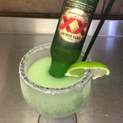 Margarita cocktail with beer bottle inserted into a glass.