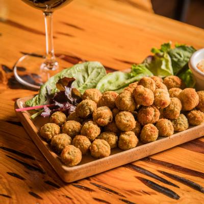 Fried anchovy stuffed olives with roasted garlic aioli sauce