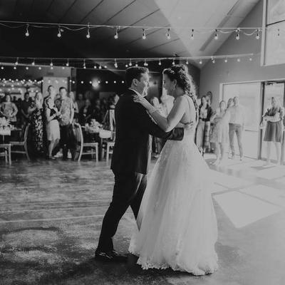 Newlyweds sharing their first dance in front of guests.