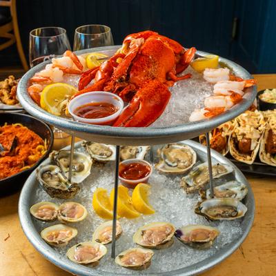 Seafood Tower for Four displayed on a table with various dishes.