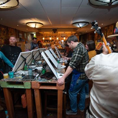 Customers painting pictures.