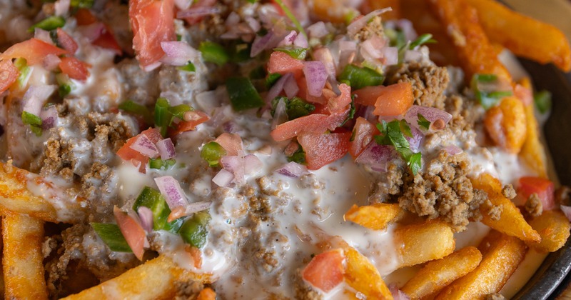 Fries with ground beef, cheese dip, and salsa