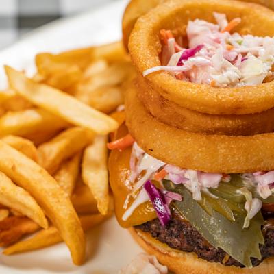 Holy Wow Burger with fries, close up.