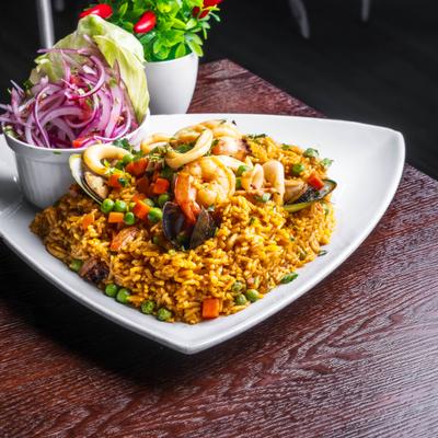 Fried rice with mixed seafood and a side salad.
