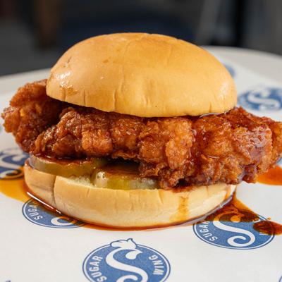 Nashville hot chicken sandwich with pickles and spicy sauce.