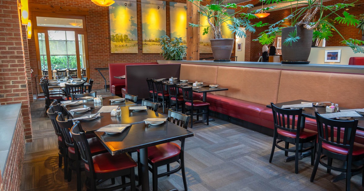 Interior, banquette bench with tables and chairs, tables and chairs ready for guests