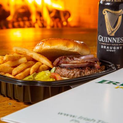 Bacon burger with fries and a can of guiness.