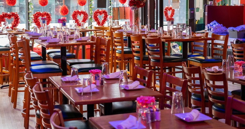 Romantic decorated interior dining area with set tables