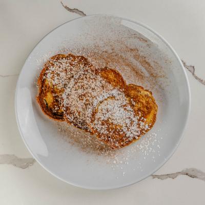 Cinnamon swirl french toast, dusted with powdered sugar.