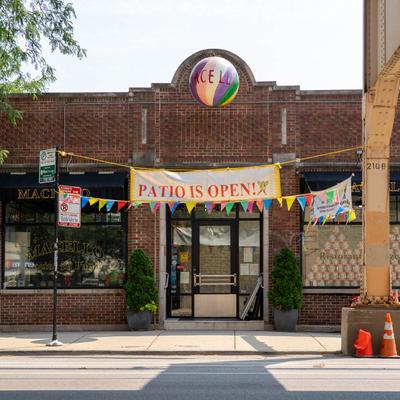 Restaurant exterior with a PATIO IS OPEN banner.
