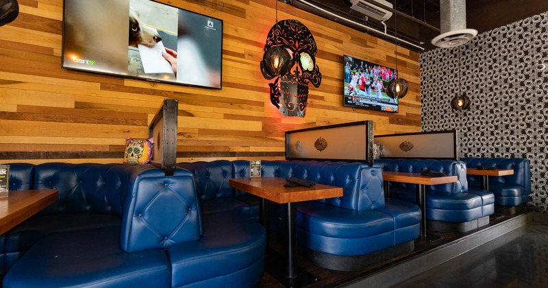 Interior, artificial leather button-tufted booths,  large wall TV screens
