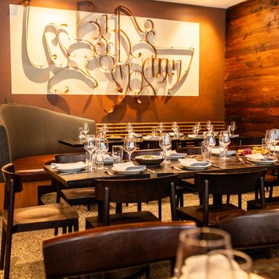 georgian-language lettering on wall in background of dining room scene