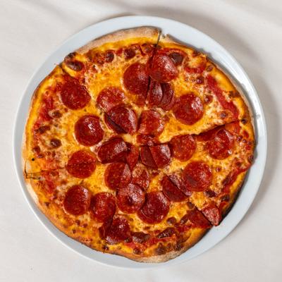 Pepperoni pizza served on a white plate, overhead view.