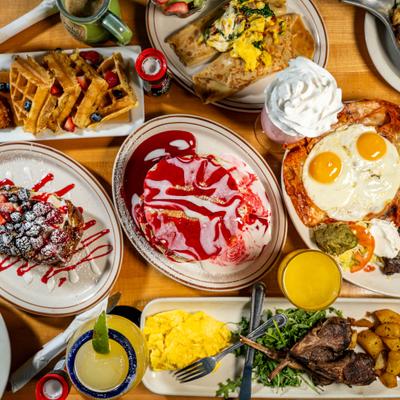 Assortment of dishes and drinks arranged on a table, overhead view.