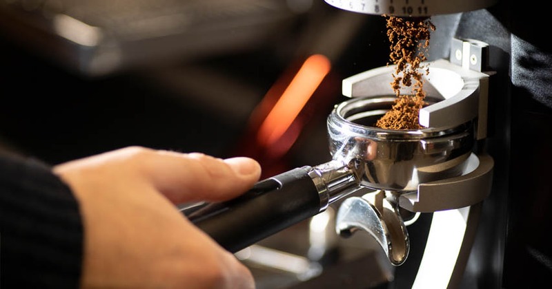 Portafilter with ground coffee, closeup