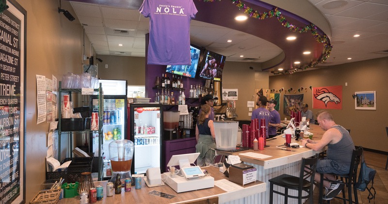 Bar, front view, drink rack, tv, t shirts merch