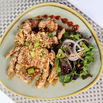 A fried soft shell crab with salad.