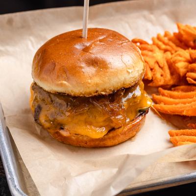 Cheeseburger skewered with a toothpick and served alongside waffle fries.