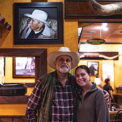 Owners posing for a portrait shot inside the restaurant.