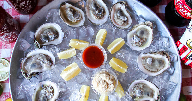Oysters on ice, lemon and two dips