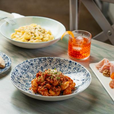 Gnocchi alla Salsiccia - House made potato dumplings, house sweet Sausage Ragu of pork, turkey, tomato, and MoMo spice blend.