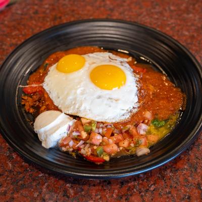 Huevos rancheros topped with two fried eggs.