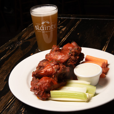 Chicken wings and a glass of beer.