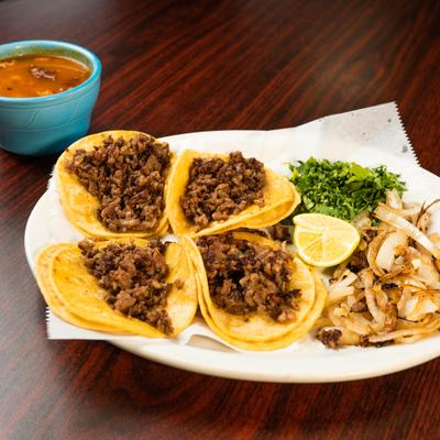 Taquitos Mexicanos served with various sides and condiments.